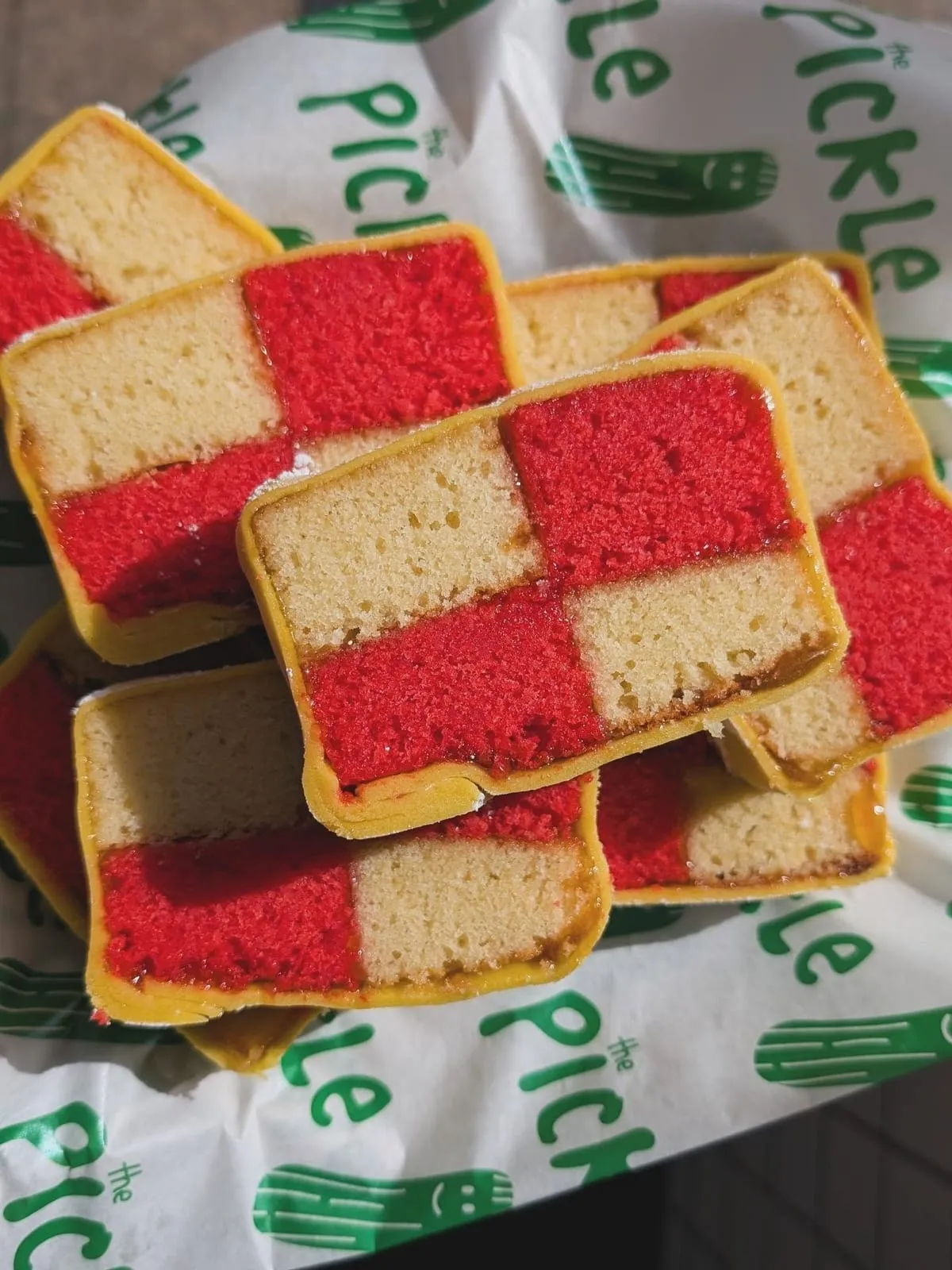 Slices of homemade pink and yellow battenberg cake at The Pickle Brighton