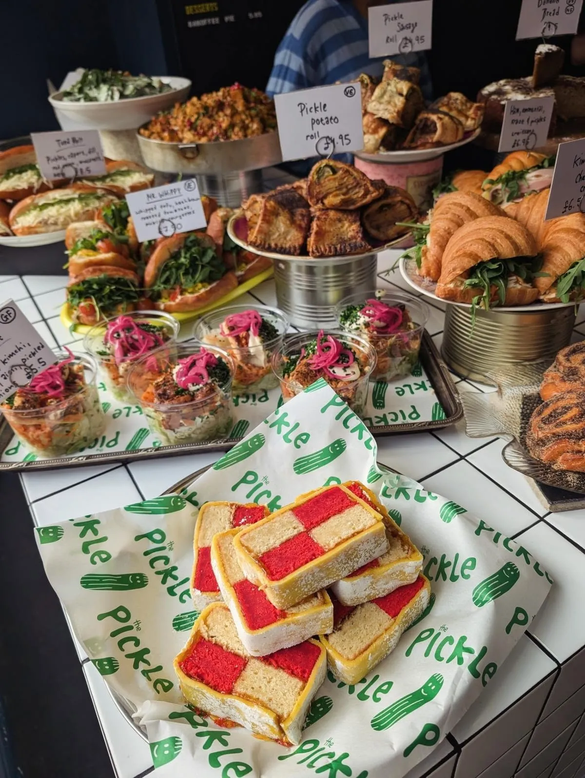 Counter spread of sandwiches, bakes and battenberg at The Pickle Kemptown
