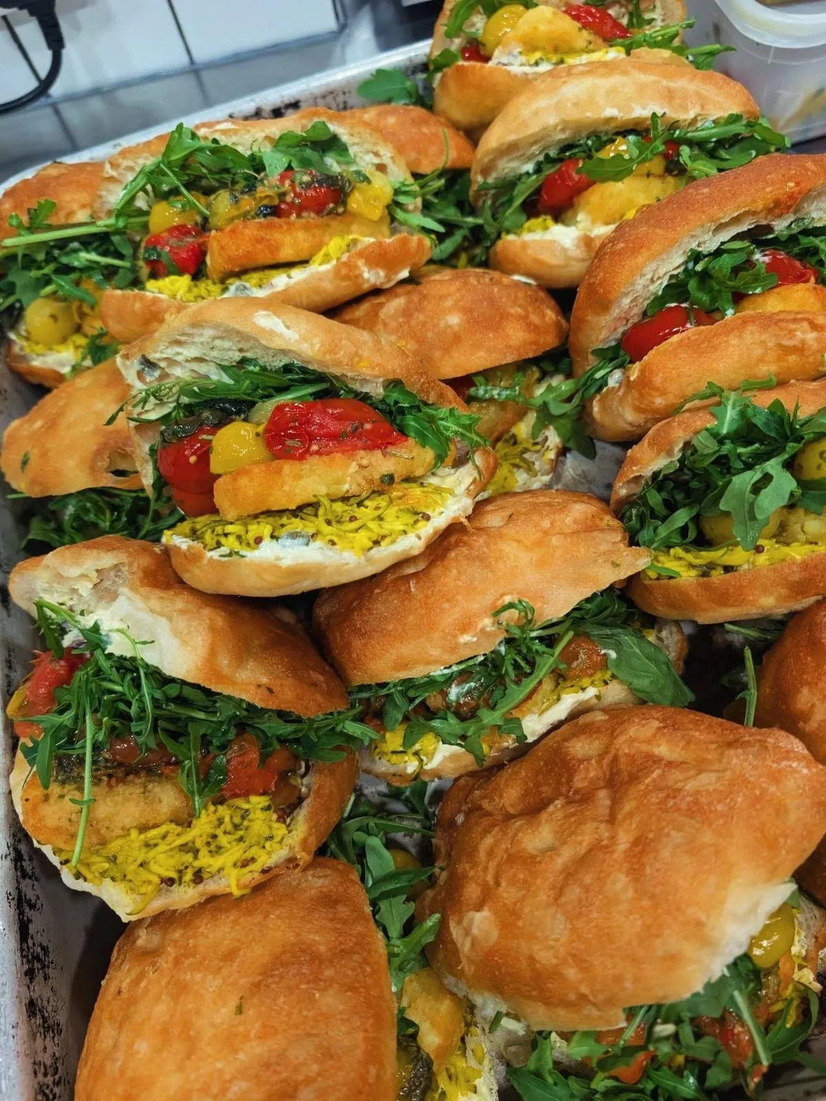 Stack of filled focaccia sandwiches with rocket at The Pickle Brighton