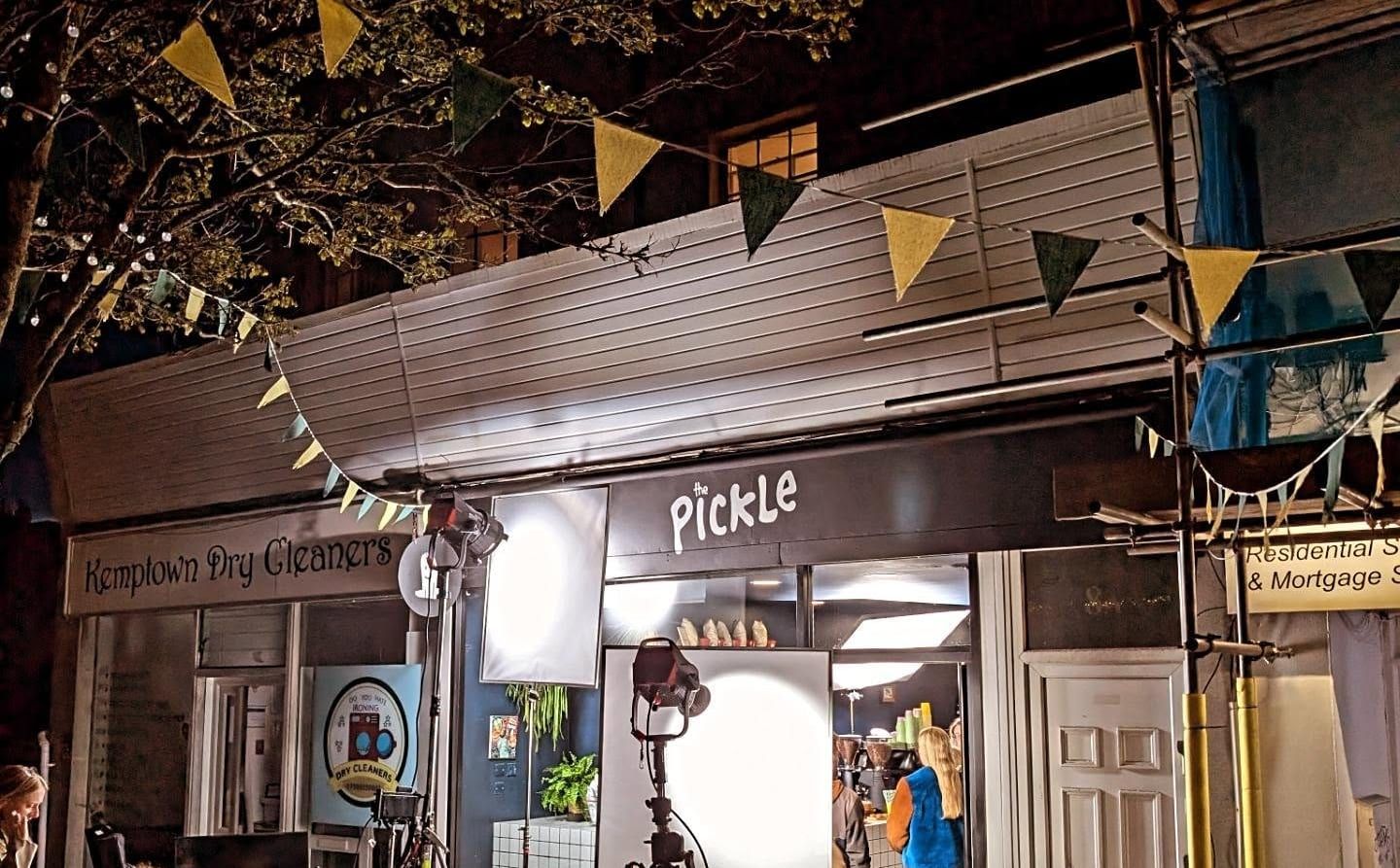 The Pickle shopfront on Bristol Road, Kemptown, lit up at night